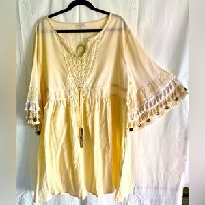 White tunic with fringe sleeves and coin embellishments